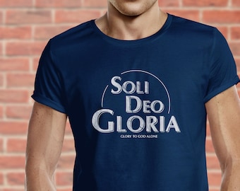May include: A navy blue t-shirt with a white graphic that says "Soli Deo Gloria" in a circle with the words "Glory to God Alone" underneath.