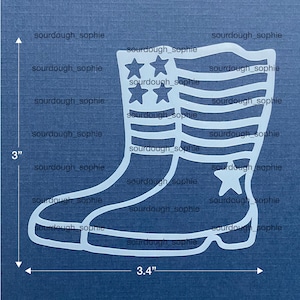 May include: A white outline of a boot shape featuring a star and stripe pattern, measuring 3 inches in height and 3.4 inches in width. The design includes four stars at the top and one star near the heel, with horizontal lines across the boot shaft.