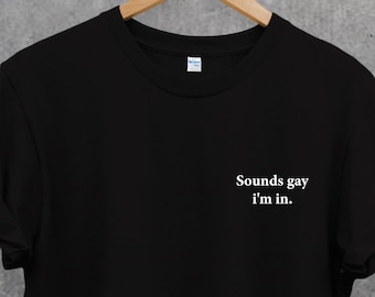 May include: Black t-shirt with white text that reads "Sounds gay, I'm in."