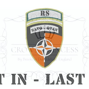 May include: A gray and orange embroidered patch with a compass and the text "NATO-OTAN" and "RS". The patch is surrounded by a decorative border.