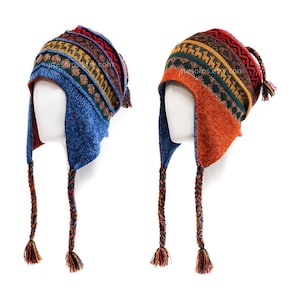 May include: Two knitted hats with ear flaps and braided ties. One hat is blue with red, yellow, and green patterns. The other is orange with similar patterns. Both hats have tassels at the ends of the braids and on the back.