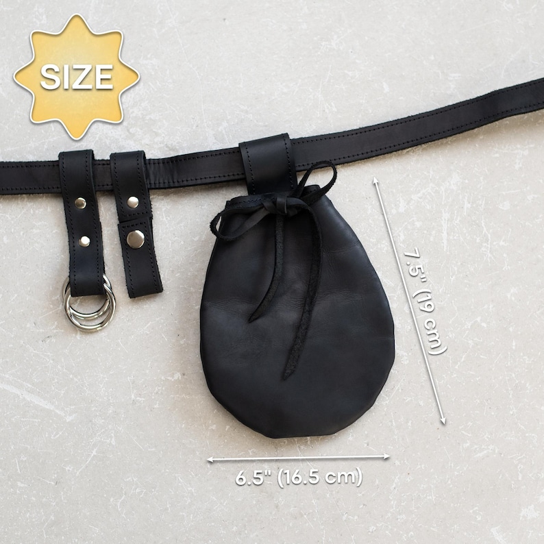 May include: Black leather pouch with a drawstring closure attached to a black leather belt with two metal rings. The pouch measures 6.5 inches wide and 7.5 inches tall.