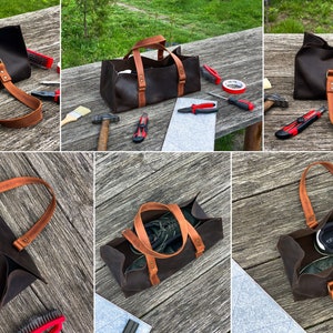 Pode incluir: Uma bolsa de ferramentas de couro castanho escuro com duas al&ccedil;as de couro bege presas por rebites met&aacute;licos. A bolsa retangular tem um design aberto e &eacute; mostrada de v&aacute;rios &acirc;ngulos, incluindo vistas com t&eacute;nis verdes no seu interior.