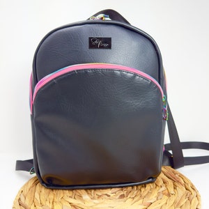 May include: Black faux leather backpack with a pink zipper and a silver logo that says "So Nice".
