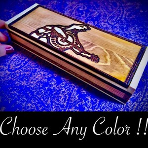 May include: A wooden box with a laser-etched design of a wolf howling at the moon. The box has a natural wood finish and is made of multiple wood types. Choose Any Color!!