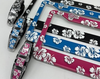 Hawaiian Flower Bundle: 2 License Plate Frames, 4 Pack License Plate Frame Screw Covers, 1 Sun Visor Sunglass Holder in Black, Blue or Pink
