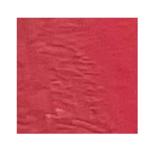 May include: A close-up of a solid red fabric with a textured surface.