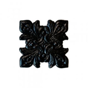 May include: Black metal decorative tile with a floral design. The tile has a square shape and intricate details.