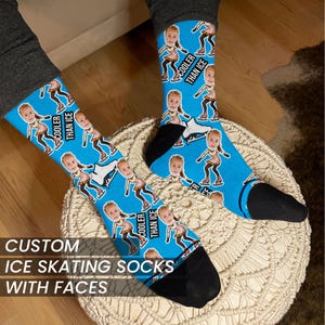 May include: A pair of blue ice skating socks with a pattern of people ice skating. The socks have the text "Cooler Than Ice" on them.