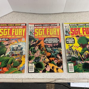 May include: Three vintage Sgt. Fury comic books from Marvel Comics Group. The covers feature action-packed illustrations of soldiers in combat, with bold text including "Blazing Battle Action" and "Sgt. Fury and His Howling Commandos."