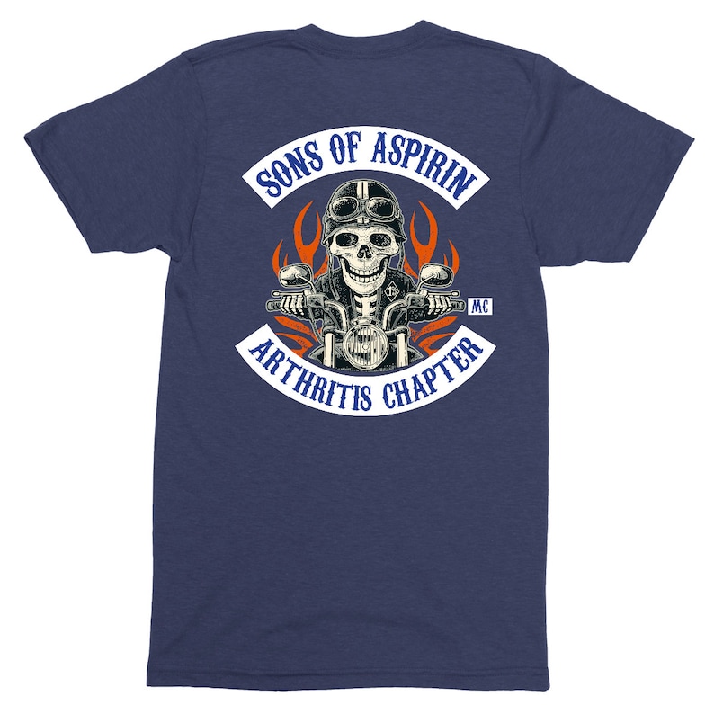 May include: A navy blue t-shirt with a white patch on the back that says "Sons of Aspirin MC Arthritis Chapter". The patch features a skull riding a motorcycle with flames behind it.