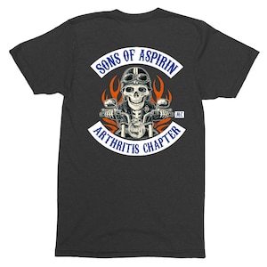 May include: A dark gray t-shirt with a white patch that says "Sons of Aspirin MC Arthritis Chapter". The patch features a skeleton riding a motorcycle with flames behind it.