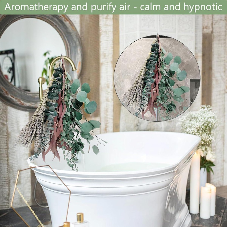 May include: A white bathtub filled with water with a bundle of dried eucalyptus and lavender hanging over the side. The bundle is tied with a brown ribbon. The bathroom has a white tiled wall and a mirror.