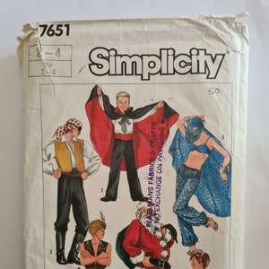 May include: Simplicity sewing pattern number 7651 for five different costumes. The costumes include a pirate, a genie, Santa Claus, a ballerina, and a vampire. The pattern is for sizes 2-4.