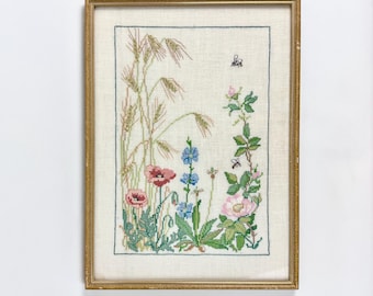 Arte têxtil botânica vintage emoldurada em linho bordado, prado de flores silvestres com papoulas e rosas selvagens, decoração de parede estilo casa de campo