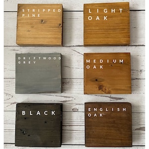May include: Six wooden blocks, each with a different wood stain colour and a label. The colours are: Stripped Pine, Light Oak, Driftwood Grey, Medium Oak, Black, and English Oak.