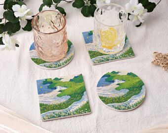 May include: Four ceramic coasters with a landscape design. Two clear drinking glasses sit on top of two of the coasters. The coasters feature a green and blue landscape with a river and yellow flowers. One coaster is round, one is square, and two are rectangular.