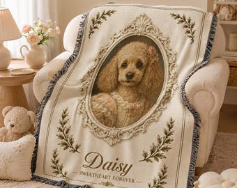 May include: A cream-colored woven throw blanket featuring a central oval frame containing a portrait of a curly-haired dog. The blanket includes the text Daisy and Sweetheart Forever, accented with green leaf motifs and fringed edges.