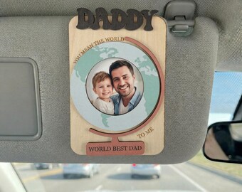 May include: Wooden photo frame with the word "DADDY" at the top. The frame features a photo of a man and a child, with the words "YOU MEAN THE WORLD TO ME" and "WORLD BEST DAD" on the frame.
