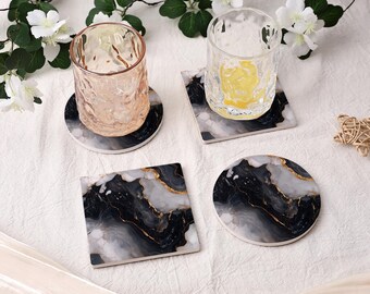 May include: Two clear textured drinking glasses and two coasters with a black, white, and gold marble pattern. One coaster is square and one is circular. The glasses are placed on top of a matching square and circular coaster set.