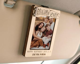 May include: A wooden photo holder with a family portrait, clipped to a car visor. The text "BEST Benjamin ever" is at the top. The bottom reads "HAPPY BIRTHDAY 2025.6.6 LOVE YOU, MARIAN."