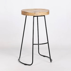 May include: A tall bar stool with a circular, light-brown wooden seat. The stool features a black metal frame with four legs and a footrest. The seat is approximately 30 cm in diameter. The stool is set against a white background.