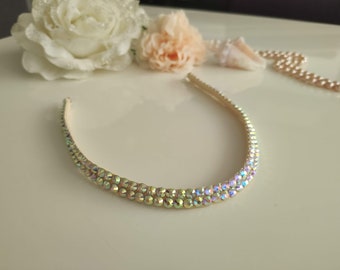 May include: A gold headband with two rows of iridescent rhinestones.