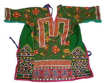 May include: A green, pink, and blue embroidered tunic with a V-neck and short sleeves. The tunic is decorated with colorful geometric patterns and mirrors.