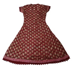 May include: A maroon dress with a floral pattern and a lace trim. The dress has short sleeves and a fitted bodice.