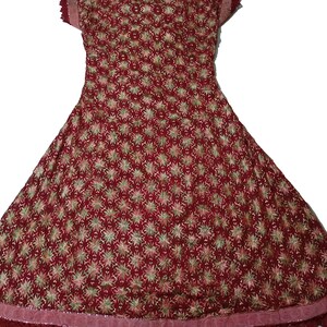 May include: A maroon-colored dress with a floral pattern and lace trim. The dress has a flared skirt and short sleeves.