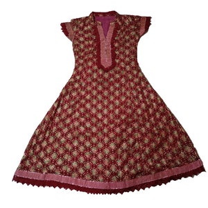 May include: A maroon dress with a floral pattern and lace trim. The dress has a V-neckline and short sleeves.
