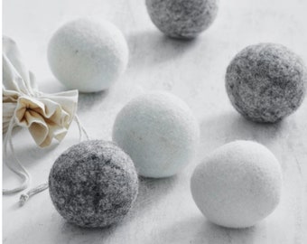 May include: Six wool dryer balls, three white and three gray, used to soften laundry and reduce drying time.