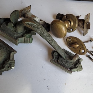 May include: A white ceramic mug with a black handle and the text "But First, Coffee" in a handwritten style. The mug is on a white surface. The mug is likely for hot beverages.