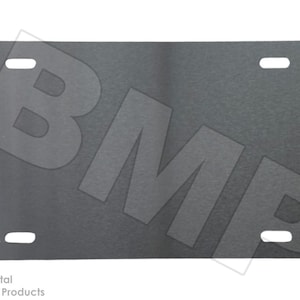 May include: A rectangular, dark gray metal license plate with four mounting holes. The letters "BMP" are prominently displayed across the plate in a lighter gray tone. The words "Best Metal Products" are printed in the lower left corner.