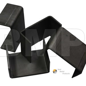 May include: Three black metal brackets, each with a different angle, are stacked on top of each other. The brackets are made of thick metal and have a rough, industrial look.