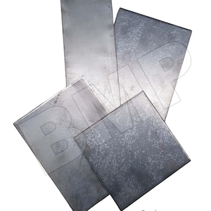 May include: Four rectangular metal sheets of varying sizes, stacked on top of each other. The sheets are a light gray color and have a slightly textured surface. The sheets are arranged in a staggered pattern, with the largest sheet at the bottom and the smallest sheet at the top. The sheets are all slightly curved, giving them a slightly organic look. The text "Best Metal Products" is visible in the lower right corner of the image.