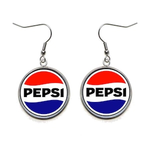May include: A pair of silver dangle earrings with a round, white, red, and blue Pepsi logo charm.