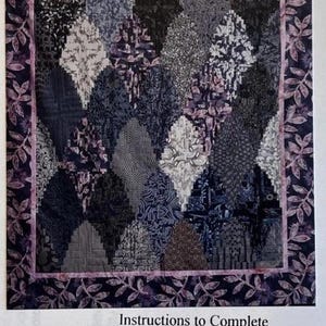 May include: A quilt pattern titled Indigo Impressions Log Cabin Rectangular Clamshells featuring a central design of interlocking dark blue, grey, and white patterned shapes surrounded by a leaf-print border. Includes instructions for a 62"x74" quilt.