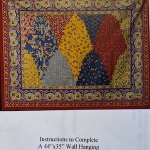May include: A rectangular quilt pattern titled Country French Clamshells Log Cabin Rectangular Clamshells. The design features a central arrangement of diamond-shaped fabric blocks in red, yellow, and blue floral prints, surrounded by a decorative border.
