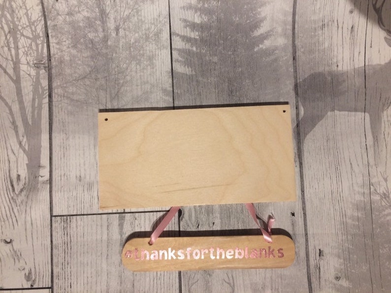May include: Two wooden signs with pink lettering. The top sign is blank and the bottom sign says "thanks for the blanks".
