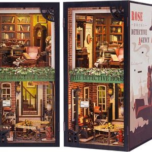 May include: A miniature dollhouse model of a detective agency, with a brick facade, a sign that reads "The Detective House", and a poster on the side that says "Rose - The Detective Agency".