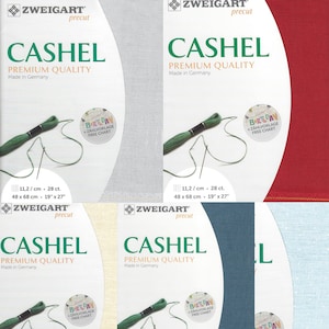 May include: Four packages of Zweigart Cashel Aida fabric, a type of fabric used for cross-stitch and needlepoint. The fabric is available in four colors: white, beige, blue, and red. Each package includes a free chart for a birthday design. The fabric is 11.2 counts per centimeter, 48 centimeters by 68 centimeters, or 19 inches by 27 inches.