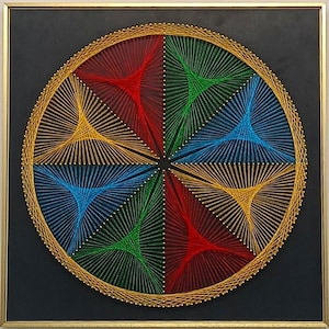May include: A square wall art piece featuring a circular string art design on a black background. The design consists of six triangular sections in red, green, and blue, created with thin threads stretched between gold pins in a gold frame.