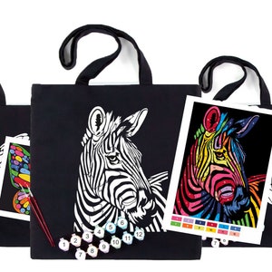 May include: Three black tote bags with paint-by-number designs. The bags feature a butterfly, a zebra, and a lion. Each bag comes with a set of paint pots and brushes.