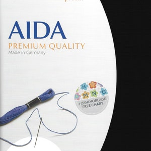 May include: A black Zweigart Aida fabric precut measuring 19 inches by 21 inches or 48 cm by 53 cm. The packaging features the text AIDA PREMIUM QUALITY, Made in Germany, and includes a blue embroidery thread skein, a needle, and a free chart.