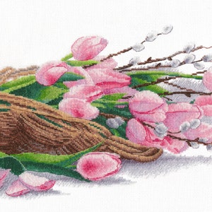 May include: A bouquet of pink tulips and pussy willow branches tied together with brown twine. The flowers are arranged in a loose, natural style, and the stems are partially covered in green leaves.