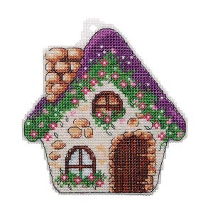 May include: A cross-stitch pattern of a small stone house with a purple roof and green vines. The house has a brown door and two windows. The roof is decorated with white stars.
