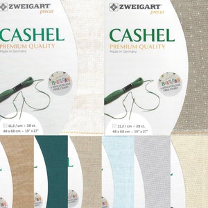 May include: A set of five fabric squares in different colors and textures. The fabric squares are beige, light blue, light gray, dark green, and a beige with white polka dots. The fabric squares are labeled with the text "11,2/cm 28 ct. 48 x 68 cm 19" x 27"". The fabric squares are for cross-stitch embroidery.