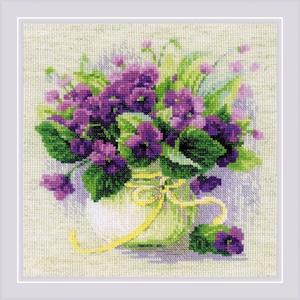 May include: A cross-stitch pattern of a bouquet of purple and green violets in a white vase with a yellow ribbon.