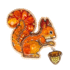 May include: A beaded squirrel brooch with orange and brown beads, holding a small beaded acorn in its paw.